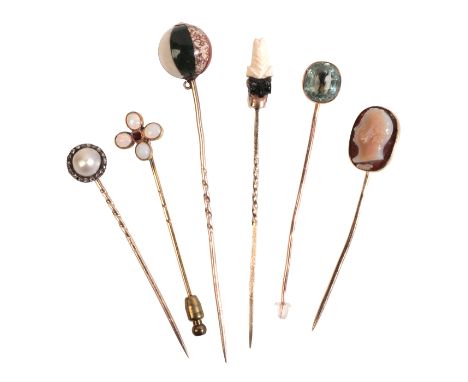 A COLLECTION OF STICK PINSin 9ct gold, including a pearl and diamond cluster stick pin; a hardstone ball stick pin; a cameo s