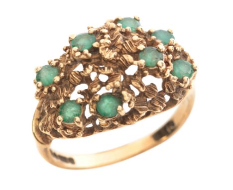 A MODERNIST EMERALD RINGin 9ct gold, set with round cut emeralds over a textured head, full British hallmarks, UK size N1/2 /