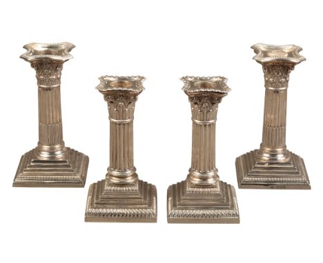 TWO SIMILAR PAIRS OF VICTORIAN CANDLESTICKSone pair by William Comyns, London 1894, the other by William Hutton, London 1897,