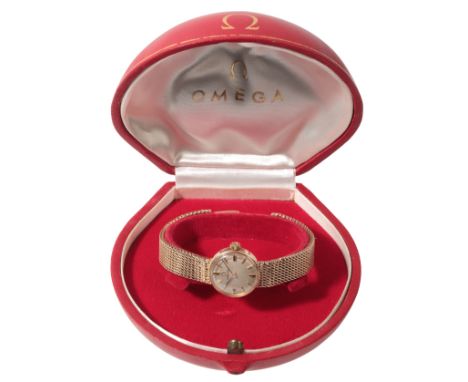 OMEGA: A LADY'S 9CT GOLD BRACELET WATCHwith manual wind movement, the silver dial with gold and black baton numerals and dark