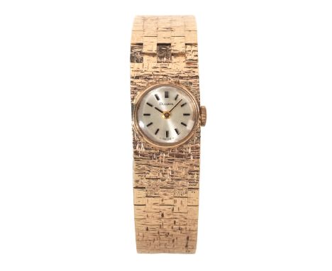 BULOVA: A LADY'S 9CT GOLD BRACELET WATCHwith manual wind movement, the silver dial with black baton numerals and gold hands, 