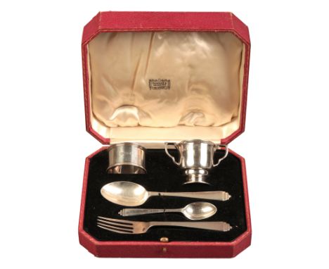 A GEORGE VI SILVER CHRISTENING SETLondon 1937, by Harrods Ltd, comprising knife, fork, spoon, napkin ring and egg cups, 4.9 t