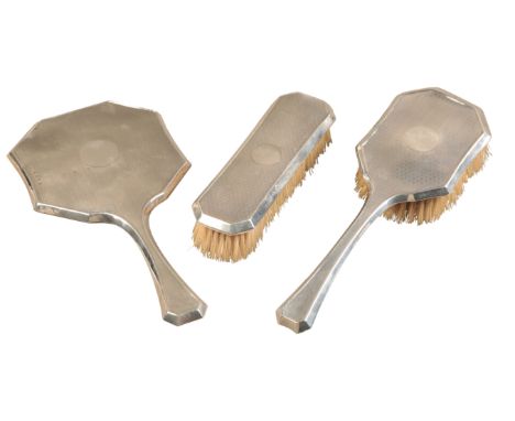 A GEORGE V SILVER DRESSING TABLE SETby Blanckensee & Son, Birmingham 1928, comprising of hand mirror, clothes brush and hair 