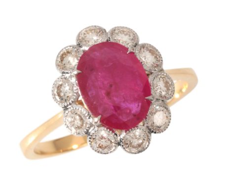 A RUBY AND DIAMOND CLUSTER RINGin 18ct gold, set with an oval cut ruby of c.2.04 carats, surrounded by a cluster of round bri