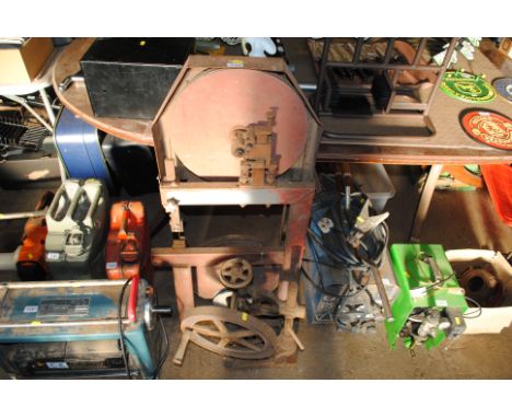 A vintage belt driven band saw and a vintage hand operated pillar drill