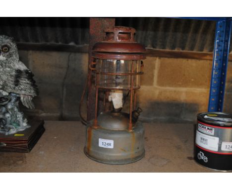 A hanging Tilley lamp with brown enamel top and swing handle