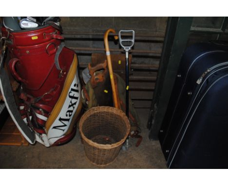 A shooting stick; a walking stick; a trouser press; a vintage canvas hiking bag; a hand saw; a wicker waste paper bin