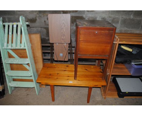 A pine coffee table; a wooden cabinet with drop front; a folding projector table