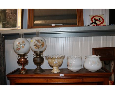 Two oil lamps together with three glass light shades