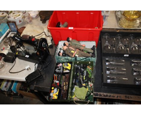A collection of action man figures and various accessories 