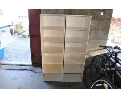 A pair of white painted wooden six tier shelf units 