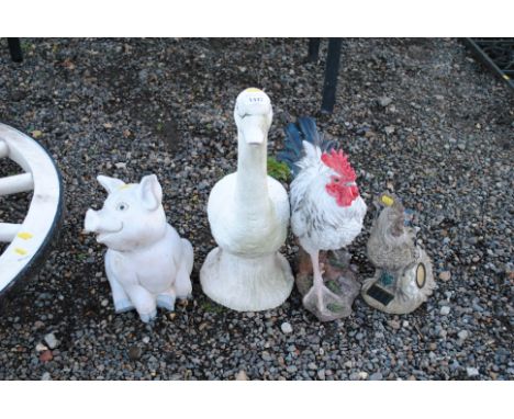 Four various garden ornaments in the form of farmyard animals 