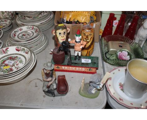 A reproduction money box, two Russian dolls and a pipe rest 