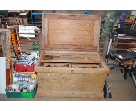 A large pine tool chest with four interior trays and contents of tools to include hand saws, smoothing plane blades, rulers, 