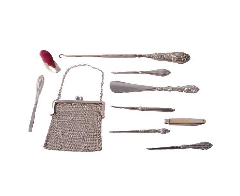 A large silver-handled buttonhook; silver-handled shoe horn; silver-handled tweezers; four other silver-handled manicure item