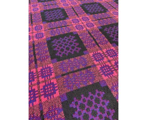 WELSH DERW WOOLEN TAPESTRY BLANKET, woven in pink, black, blue and claret, with fringe, 230 x 220cms