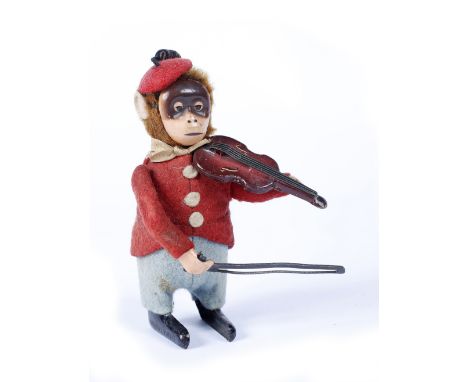 A Schuco clockwork figure of a monkey playing a violin, dressed in felt clothing and stamped Schuco patent Made In Germany