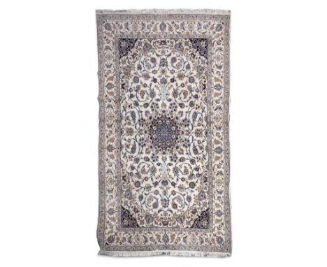 A Persian ivory ground small carpet with central medallion and trailing foliate designs, 200cm x 310cm