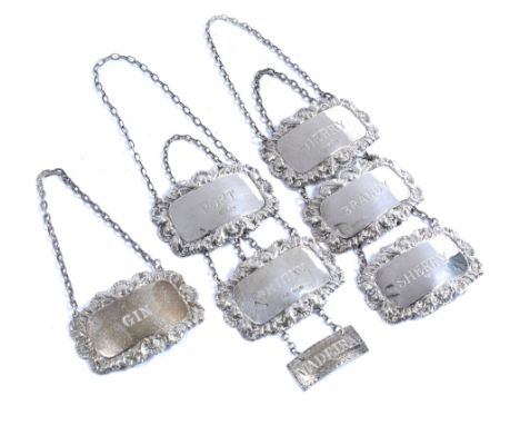 A collection of seven silver decanter labels in similar styles, two sherry, gin, whisky, brandy and port, and a further Madei