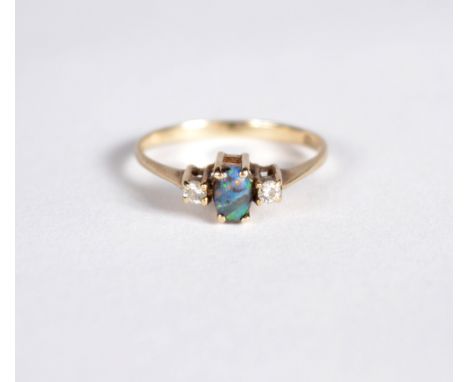 A 9ct gold ring set with a central black opal and with diamonds to shoulders