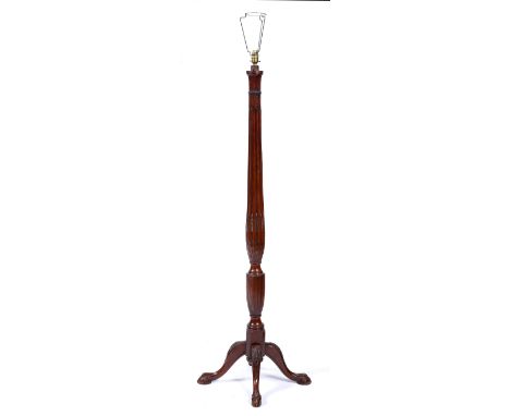 A mahogany standard lamp with carved column pillar and carved supports