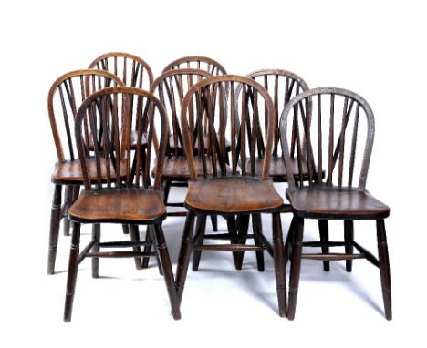 A set of eight elm stick back dining chairs stamped J Elliott & Sons 1915