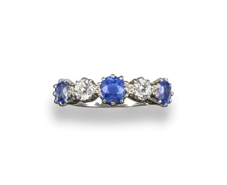 A sapphire and diamond-set five stone ring, set with three oval-shaped sapphires and two old circular-cut diamonds in white g