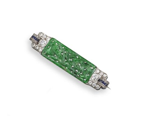 An Art Deco jade and diamond brooch, set with a rectangular panel of green jadeite set either side with circular-cut scroll d