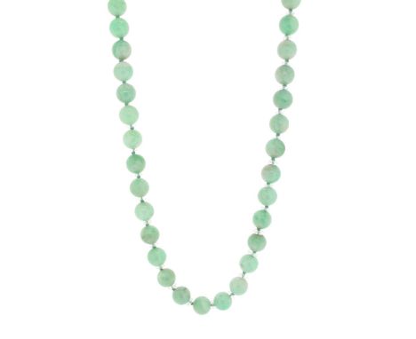 A single-row jade bead necklace, the pale green jade beads graduate from 7.11 to 9.77mm, with a metal clasp. 56cm long.