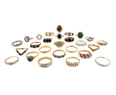 Twenty six gem set gold rings, including an emerald and diamond half hoop ring, three diamond half hoop rings, four gold ring