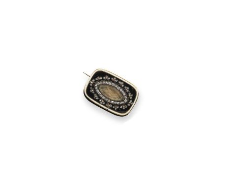 An early 19th century enamel and diamond mourning brooch, set with a glazed locket compartment within foliate diamond border 