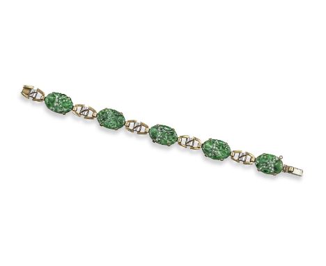 A jade bracelet, the five oval pierced and carved jade plaques are joined with yellow and white gold links. 18cm long.