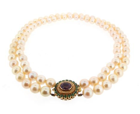 A two row cultured pearl necklace, the pearls measure approximately 9.5mm. 47cm long. The gold clasp set with an oval-shaped 