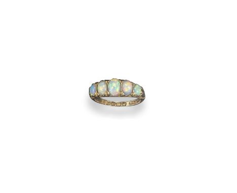 An opal half hoop ring, the graduated white opals are set in carved and pierced yellow gold mount. Size K 1/2.