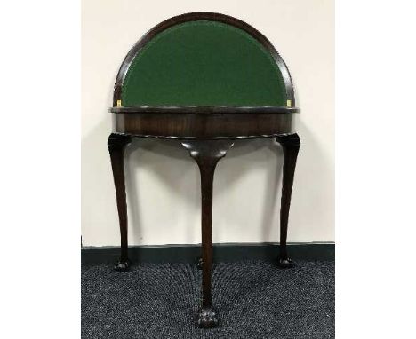 A foldover card table on claw and ball feet 