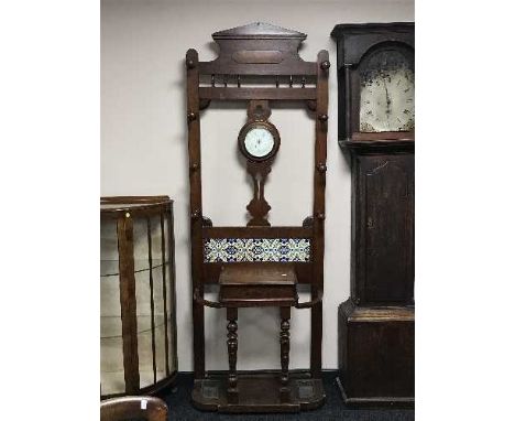 A late Victorian oak hall stand fitted a barometer 