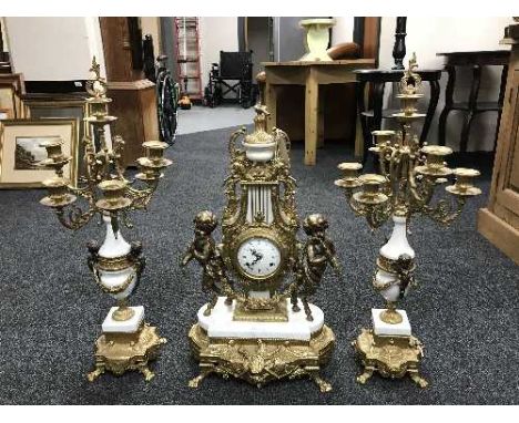 An ornate gilt three-piece clock garniture.  (3)  