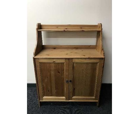 A pine cabinet fitted a shelf above 