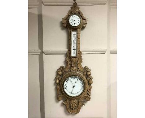 An early twentieth century carved light oak barometer / clock / thermometer 