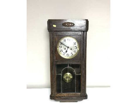 An early 20th century oak wall clock with silvered dial 