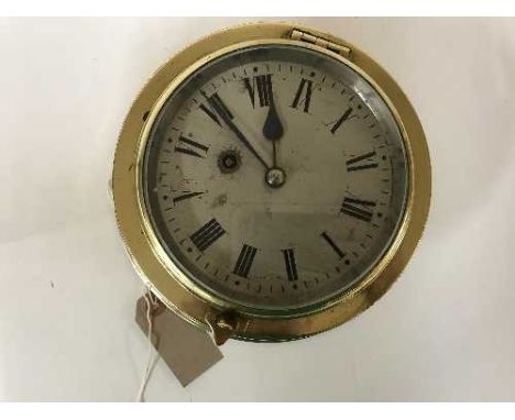 A circular brass ship's wall clock