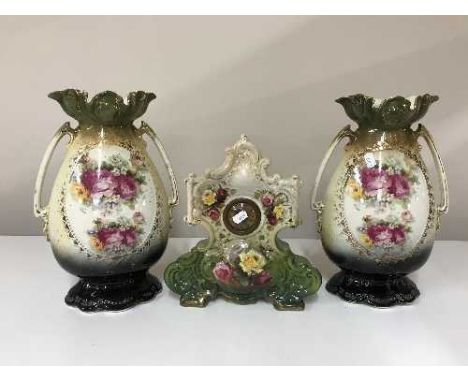 An early 20th century china mantel clock and a pair of vases 