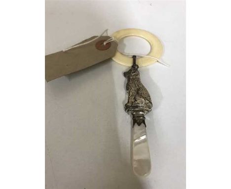 A silver and mother of pearl child's rattle in the form of a dog