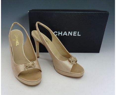 A pair of Chanel gold metallic leather peep-toe slingback high-heeled shoes,
with gilt metal bow to front, the metallic leath