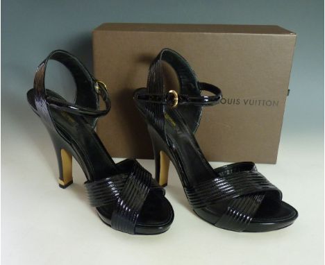 A pair of Louis Vuitton black patent leather high heel sandal shoes,
with cross ribbed section to toe and strap to ankle,
siz
