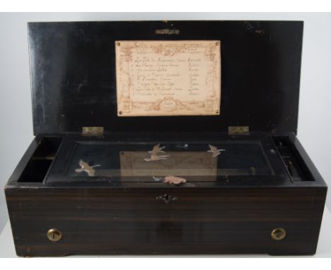 Swiss music box, 19th century, walnut and ebonised case, marquetry inlaid to the lid with musical score and instruments, 28cm