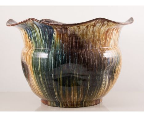 A large Bretby Art Pottery jardiniere, undulating rim and dimpled body, streaked glazes, 22cm high x 35cm wide, together with