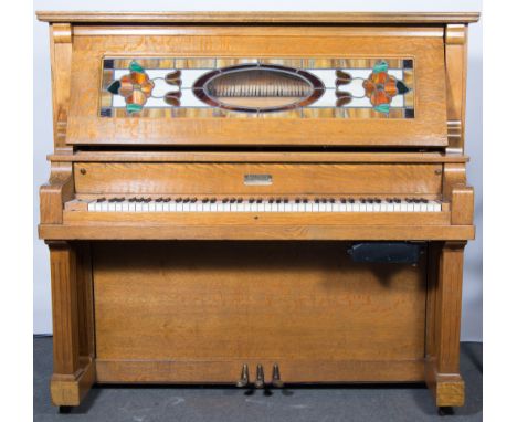 Modern oak self playing upright pianocorder, with stained glass panel, W150cm, D68cm, H145cm, together with a quantity of pia