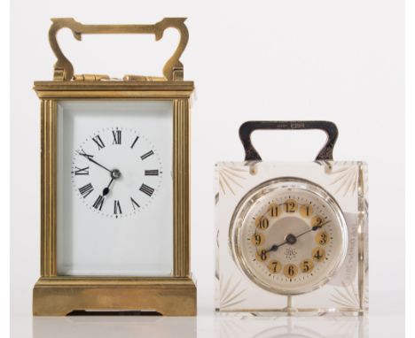A French brass carriage clock, rectangular enamelled dial with Roman numerals, raised on bracket feet, 16cm with key and a Ju