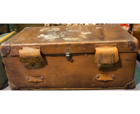 Leather trunk, carry handle to each side, label reading 'Warranted Flaxite Fibre', 83cm x 50cm x 34cm; some luggage labels in